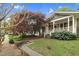 Exterior view of home showcasing the front yard with mature trees and landscaping at 306 Perry St, Raleigh, NC 27608