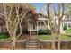Charming home exterior with stone-lined entry steps, a covered porch, and lush landscaping at 306 Perry St, Raleigh, NC 27608