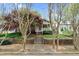 Charming home exterior featuring a welcoming porch, stone wall, and mature landscaping at 306 Perry St, Raleigh, NC 27608