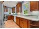 Updated kitchen boasts custom wood cabinets, stone countertops, and modern appliances at 306 Perry St, Raleigh, NC 27608
