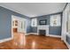Open living room showcasing hardwood floors and a decorative fireplace at 306 Perry St, Raleigh, NC 27608