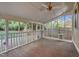 Enclosed porch with wood floor, white railing and views of the private backyard at 306 Perry St, Raleigh, NC 27608