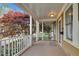 Covered porch features a white railing, providing a relaxing outdoor space at 306 Perry St, Raleigh, NC 27608