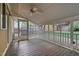 Covered porch with wood flooring, white trim, and views of the fenced backyard at 306 Perry St, Raleigh, NC 27608