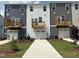 Rear view of townhomes showcasing private balconies and garage access at 331 Deercroft Dr, Apex, NC 27539