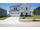 Charming two-story home featuring a two-car garage, teal front door, and a well-manicured lawn at 3409 Rosebush Dr, Zebulon, NC 27597