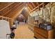 Spacious unfinished attic with exposed wood beams and insulation, offering potential for customization and additional storage at 36 Wellspring Cir, Clayton, NC 27527
