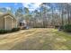 Expansive backyard featuring lush lawn, mature trees, and a charming screened porch, perfect for outdoor relaxation at 36 Wellspring Cir, Clayton, NC 27527