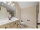 Elegant bathroom featuring a sink with vanity, toilet, and tiled walls, creating a bright and functional space at 36 Wellspring Cir, Clayton, NC 27527