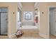 Elegant bathroom featuring a soaking tub, decorative window, and separate shower for relaxation and comfort at 36 Wellspring Cir, Clayton, NC 27527