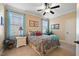 Spacious bedroom with neutral walls and carpet, a large window, and a ceiling fan for added comfort at 36 Wellspring Cir, Clayton, NC 27527