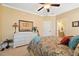 Well-lit primary bedroom with neutral carpet and walls, a ceiling fan, and a large window for lots of light at 36 Wellspring Cir, Clayton, NC 27527