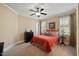 Traditional bedroom with two windows, neutral carpeting and walls, and bedding with a red quilt at 36 Wellspring Cir, Clayton, NC 27527