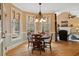 Bright breakfast nook with hardwood floors, large windows, and an adjacent living room with a fireplace at 36 Wellspring Cir, Clayton, NC 27527