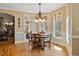 Charming dining area with hardwood floors, natural light, and classic chandelier at 36 Wellspring Cir, Clayton, NC 27527