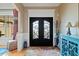Elegant entryway featuring ornate double doors, a decorative rug, and stylish accents at 36 Wellspring Cir, Clayton, NC 27527