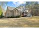 Well-maintained home exterior featuring a screened porch and spacious backyard, perfect for outdoor living at 36 Wellspring Cir, Clayton, NC 27527