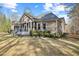 Beautiful landscaping surrounds the screened porch with views of the lush greenery in the backyard at 36 Wellspring Cir, Clayton, NC 27527