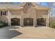 Spacious three-car garage features ample storage, workshop area, and convenient access to the home at 36 Wellspring Cir, Clayton, NC 27527