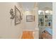 Hallway with hardwood floors and decorative wall art and ample sunlight, giving a sense of space at 36 Wellspring Cir, Clayton, NC 27527