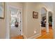 Inviting hallway with hardwood floors, archway, and neutral paint, leading to a light-filled living space at 36 Wellspring Cir, Clayton, NC 27527