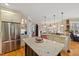 Kitchen featuring white cabinets, granite countertops, an island, and stainless appliances at 36 Wellspring Cir, Clayton, NC 27527