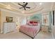 Spacious main bedroom featuring tray ceiling, neutral décor, and ample natural light with a ceiling fan at 36 Wellspring Cir, Clayton, NC 27527