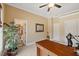 Home office featuring a wooden desk, ceiling fan, neutral walls and carpet, as well as a plant in the corner at 36 Wellspring Cir, Clayton, NC 27527