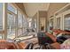 Inviting screened porch with stylish furniture, creating a cozy and serene outdoor living space at 36 Wellspring Cir, Clayton, NC 27527