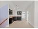 Wet bar showcases sleek black cabinets, neutral countertops, and seamless access to adjacent room at 36 Wellspring Cir, Clayton, NC 27527
