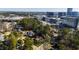 The home is situated among lush trees with city buildings in the distance at 508 Currituck Dr, Raleigh, NC 27609