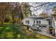 An outdoor dining area sits on a paved patio in the backyard, complemented by a playset and green lawn at 508 Currituck Dr, Raleigh, NC 27609