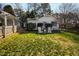 The well-maintained backyard showcases a lush lawn and charming white garden chairs, ideal for outdoor relaxation at 508 Currituck Dr, Raleigh, NC 27609