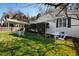 The backyard features a well-manicured lawn and white garden furniture, inviting relaxation and outdoor enjoyment at 508 Currituck Dr, Raleigh, NC 27609