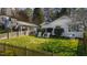 The lush backyard offers plenty of space and features a fence for privacy, complemented by white seating at 508 Currituck Dr, Raleigh, NC 27609