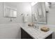 Well-lit bathroom with a marble countertop, decorative mirror, and white subway tile at 508 Currituck Dr, Raleigh, NC 27609