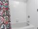 Clean bathroom with white tiled shower, and colorful decorative shower curtain at 508 Currituck Dr, Raleigh, NC 27609