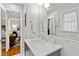 Elegant bathroom featuring a marble counter, decorative mirrors, and access to the main bedroom at 508 Currituck Dr, Raleigh, NC 27609
