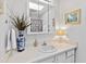 Bright bathroom with a skylight, decorative mirror, and unique floral accents at 508 Currituck Dr, Raleigh, NC 27609