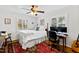 Comfortable bedroom with neutral walls, wooden floors, a ceiling fan, and a built in desk at 508 Currituck Dr, Raleigh, NC 27609