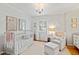 Cozy Bedroom with a crib, armchair, soft carpet, and plenty of natural light at 508 Currituck Dr, Raleigh, NC 27609