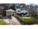 This exterior view of the house shows a carport, a fenced yard, and seating, enhancing curb appeal at 508 Currituck Dr, Raleigh, NC 27609