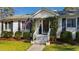 Inviting front porch with a charming entryway, complemented by manicured landscaping at 508 Currituck Dr, Raleigh, NC 27609