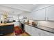 Bright kitchen features white cabinetry, stainless steel appliances, black countertops, and a colorful rug at 508 Currituck Dr, Raleigh, NC 27609