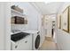Laundry room with modern washer and dryer, woven storage baskets, and neutral walls at 508 Currituck Dr, Raleigh, NC 27609