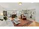 Bright living room featuring hardwood floors, a decorative rug, and an open layout to the kitchen at 508 Currituck Dr, Raleigh, NC 27609