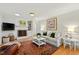 Living room featuring a fireplace, hardwood floors, comfortable seating, and natural light at 508 Currituck Dr, Raleigh, NC 27609