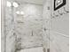 Modern shower features marble tile, glass door, rainfall shower head, and built-in niche at 508 Currituck Dr, Raleigh, NC 27609