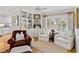 Sitting area with hardwood floors, bright windows, comfortable chairs, and built in shelves at 508 Currituck Dr, Raleigh, NC 27609