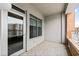 Private balcony with floor tiles, white door and window overlooking the building's exterior at 510 Glenwood Ave # 602, Raleigh, NC 27603